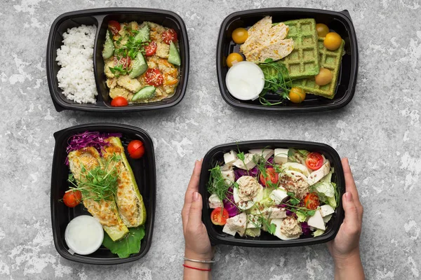 Plastic containers with delicious food on gray background — Stock Photo, Image