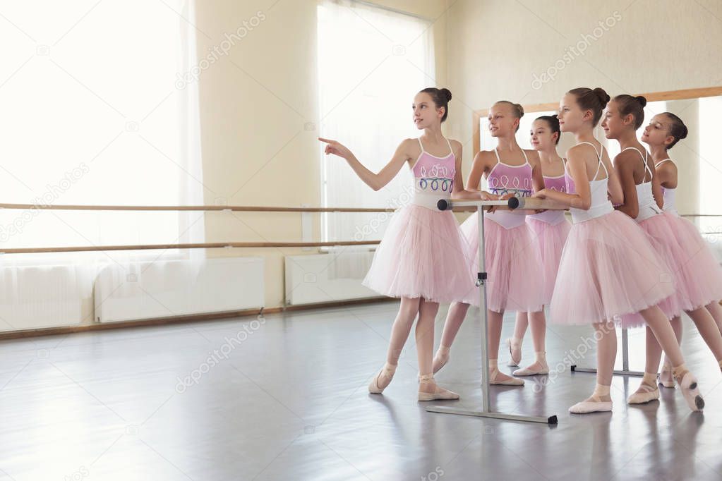Ballerinas having break in practice at ballet studio