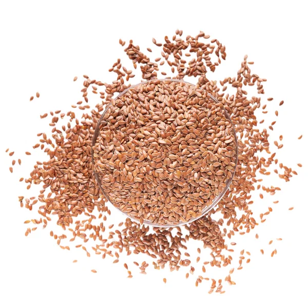 Flax seeds scattered and poured into bowl — Stock Photo, Image
