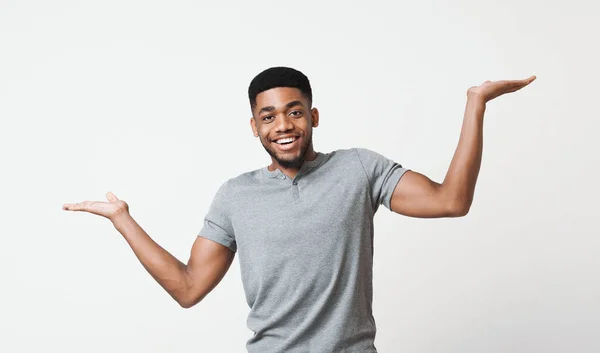 Young black man making scale with his hands — Stock Photo, Image