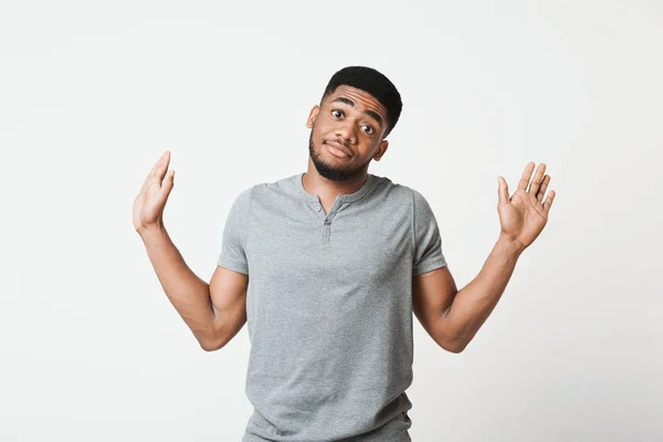 Confused black manraising his hands and looking at camera — Stock Photo, Image