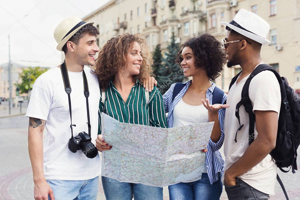 Multiracial couples discussing new locations using map