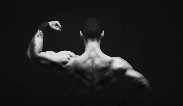 Unrecognizable man shows strong back muscles closeup — Stock Photo, Image