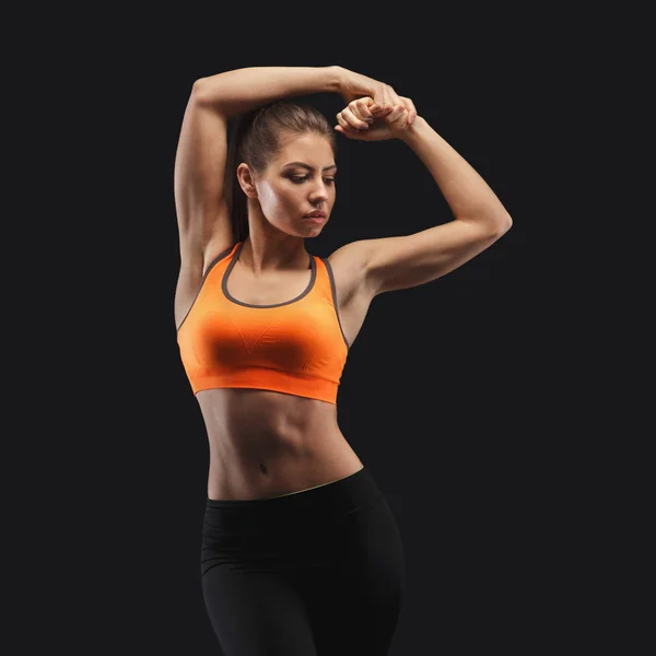Athletic woman on black background
