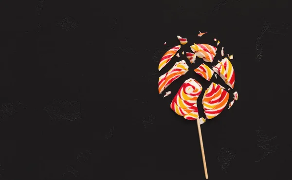 Crashed lollipop candies on black background — Stock Photo, Image