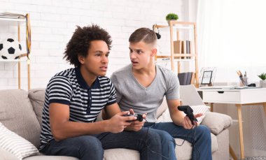 Arkadaşları ve video oyunları. İki genç oyun konsolunda oynamak