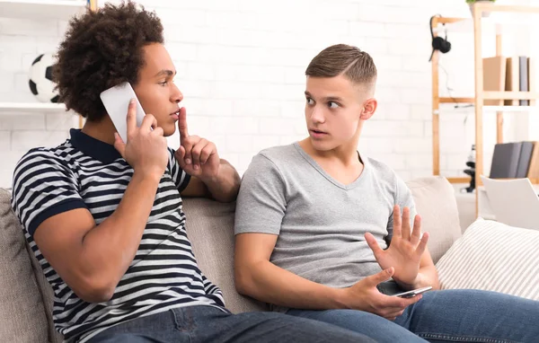 Guy asking for silence while talking on phone — Stock Photo, Image