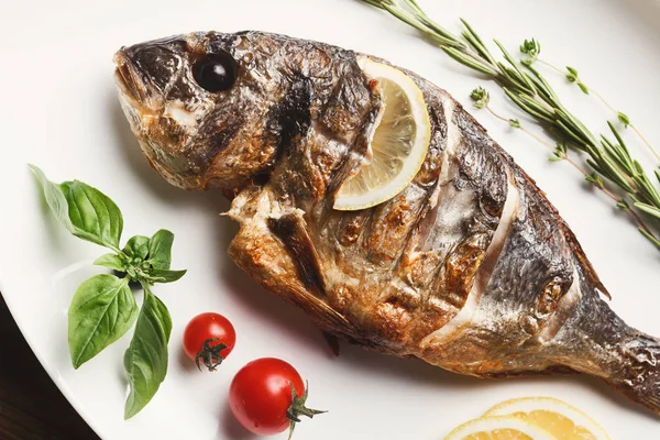 Whole grilled dorado and sea bass on table — Stock Photo, Image