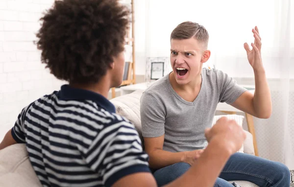 Diverse roommates arguing in the living room at home — Stock Photo, Image