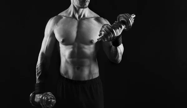 Strong athletic man with dumbbell showes naked muscular body — Stock Photo, Image