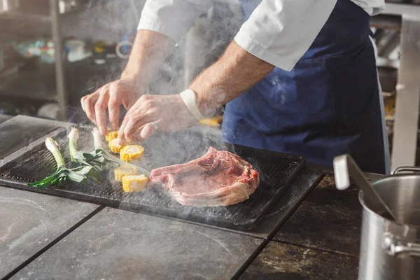 Chef cooking juicy beef steak at restaurant kitchen — Stock Photo, Image