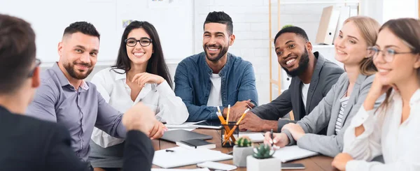Happy business team listening to director at meeting — Stock Photo, Image