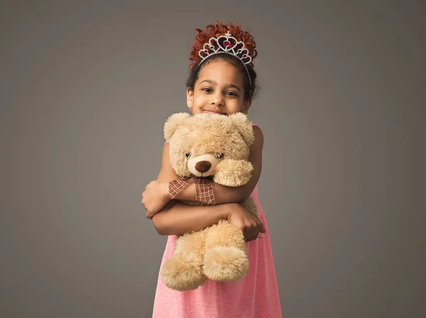 Cute black child girl in princess tiara with toy — Stock Photo, Image