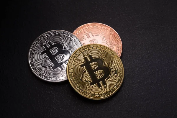 Golden, silver and bronze bitcoin on black background — Stock Photo, Image