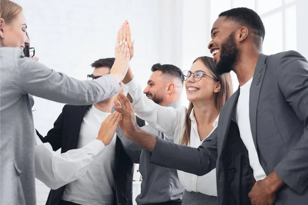 Team achievement, diverse business people giving high five — Stock Photo, Image