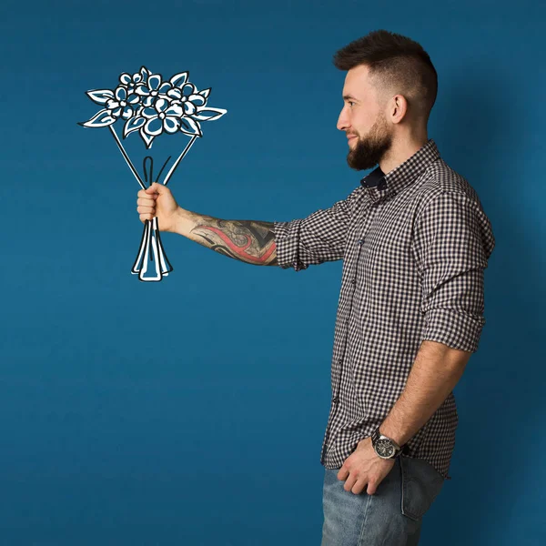 Joven sosteniendo ramo dibujado en la mano en el estudio, collage —  Fotos de Stock