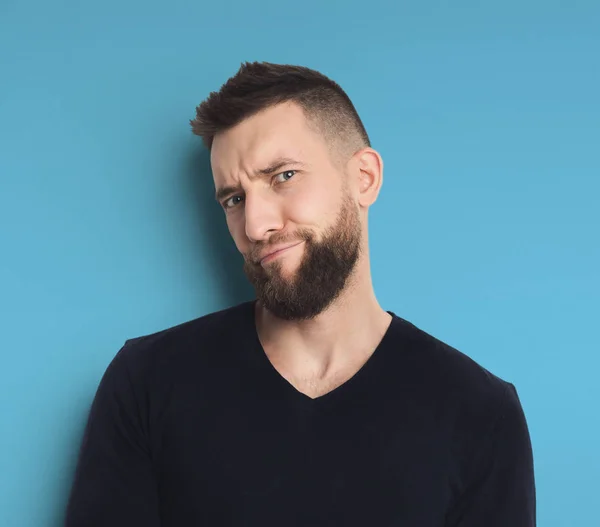 Emotional man posing on blue background — Stock Photo, Image