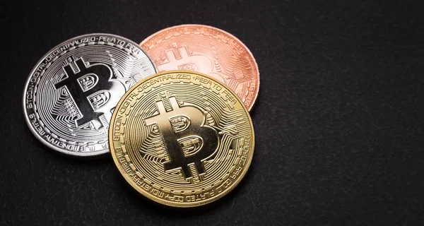 Golden, silver and bronze bitcoin on black background — Stock Photo, Image
