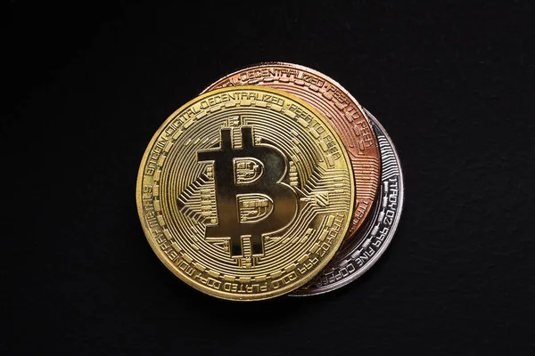 Golden, silver and bronze bitcoin on black background — Stock Photo, Image