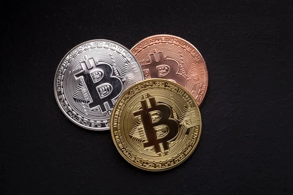 Golden, silver and bronze bitcoin on black background — Stock Photo, Image