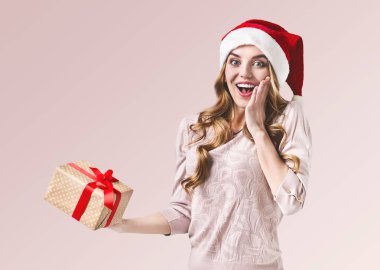Surprised happy beautiful girl holding present clipart