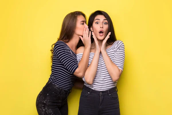 Two beautiful girls telling each other secret — Stock Photo, Image