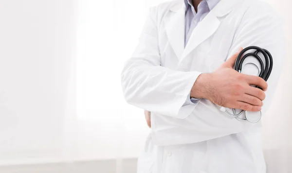 Doctor in white coat holding stethoscope in his hand — Stock Photo, Image