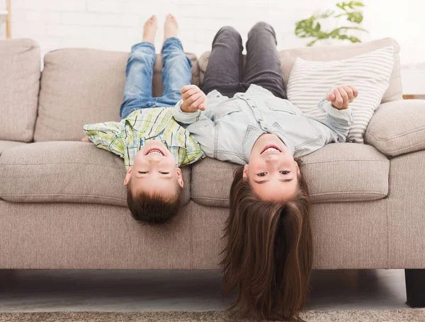 Go crazy together. Relaxing upside down on sofa — Stock Photo, Image
