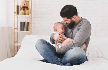 Uykucu şirin yeni doğan bebek ağlıyor tutan genç baba