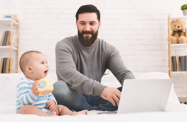 Businessman working from home and watching child — Stock Photo, Image