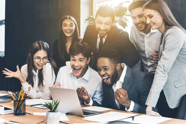 Gente feliz de negocios celebrando el éxito mirando a la computadora portátil — Foto de Stock