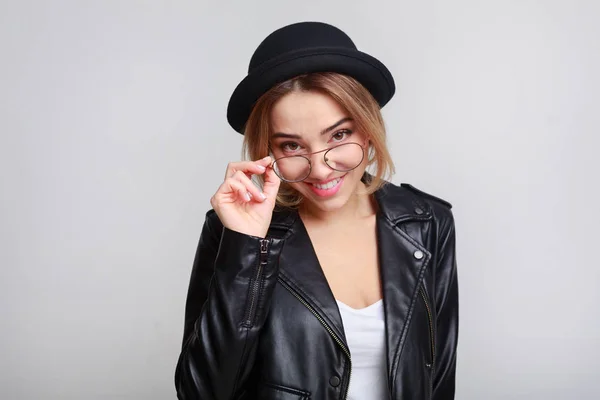 Joyful woman posing with glasses in black jacket — Stock Photo, Image