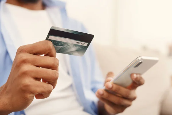 African-american man making transaction using mobile application