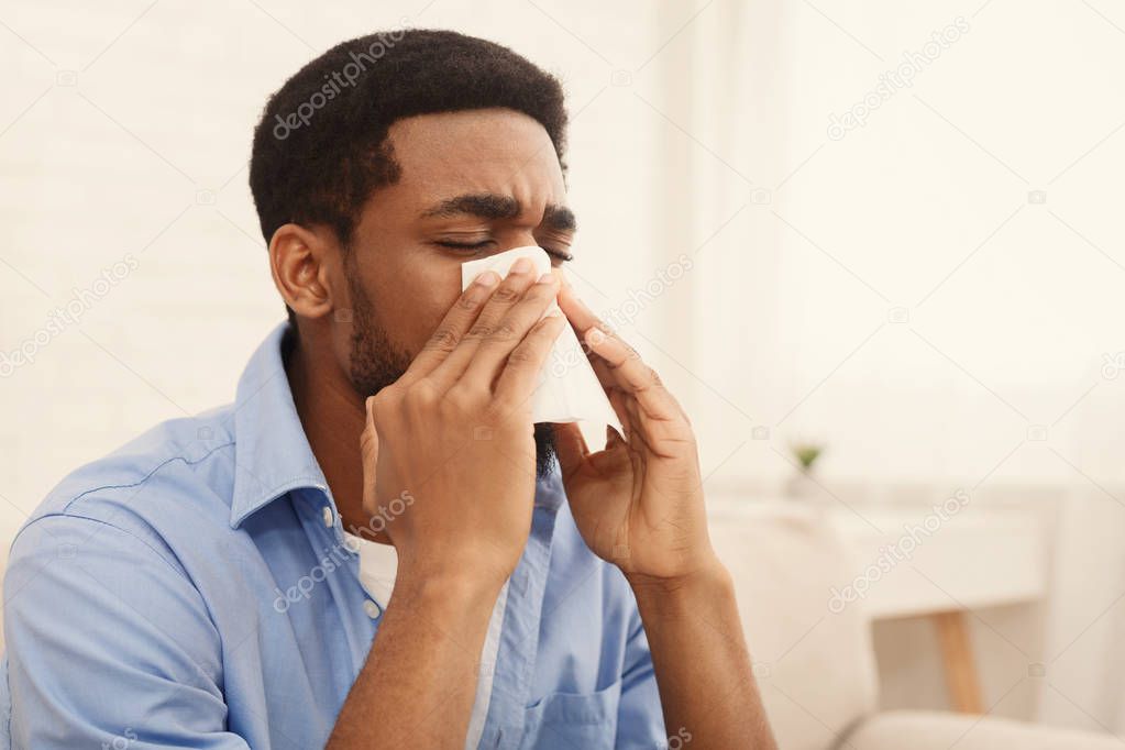 African-american man man has runny nose at home