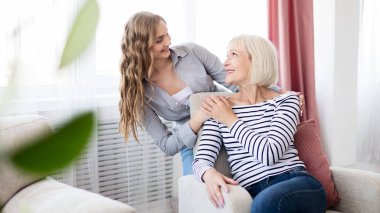 Sevimli genç kız annesini sevgiyle kucaklıyor.