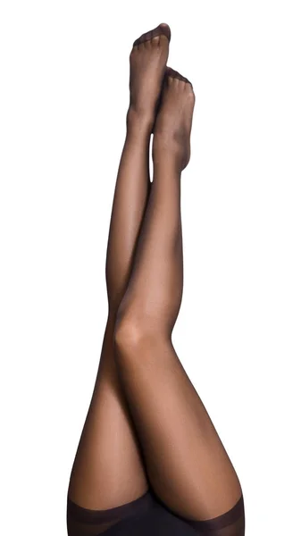 Womans legs covered in black tights in air — Stock Photo, Image