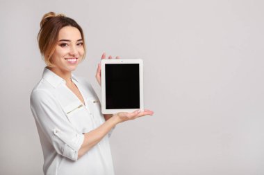 Neşeli kadın tablet bilgisayar görüntüsünü gösterilen