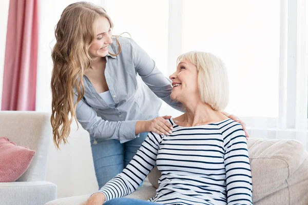 Positiv kvinna och hennes dotter vilar hemma — Stockfoto