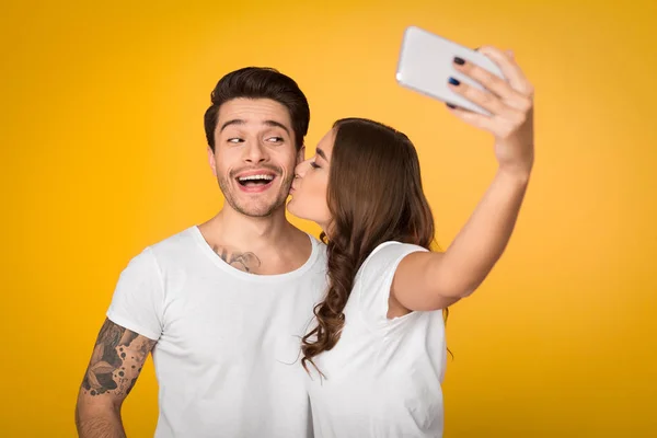 Güzel çift alarak selfie sarı arka plan üzerinde — Stok fotoğraf
