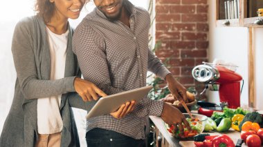 Genç siyah çift dijital tablet mutfakta kullanma