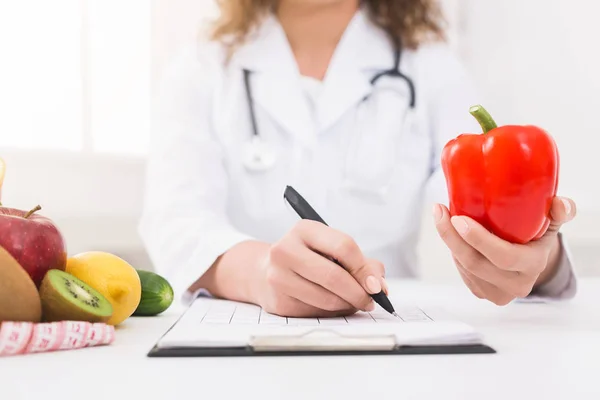 Female nutritionist counting calories in hospital, closeup — Stock Photo, Image