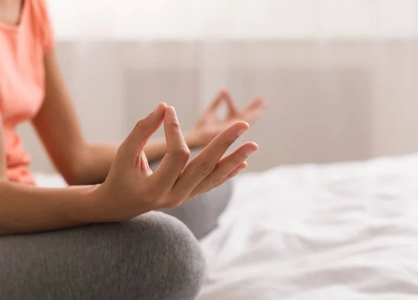 Woman doing yoga lotus pose on bed after wake up — Stock Photo, Image