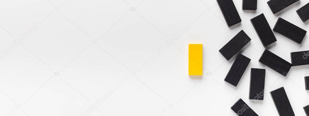 Yellow block standing out of black ones