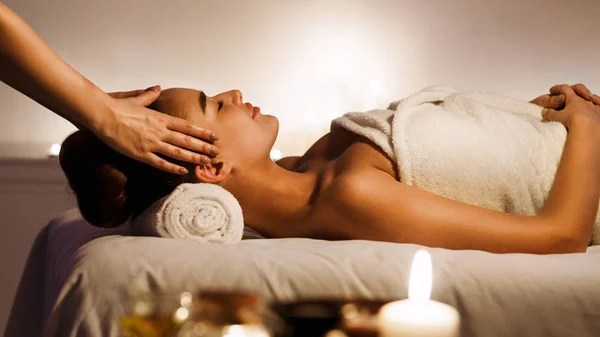 Jovem mulher desfrutando de massagem facial no salão de spa — Fotografia de Stock