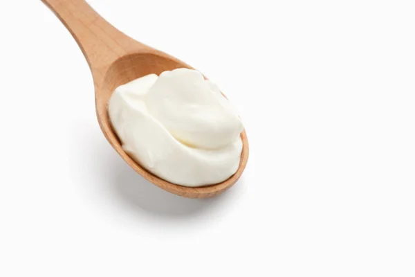 Sour cream in wooden spoon — Stock Photo, Image