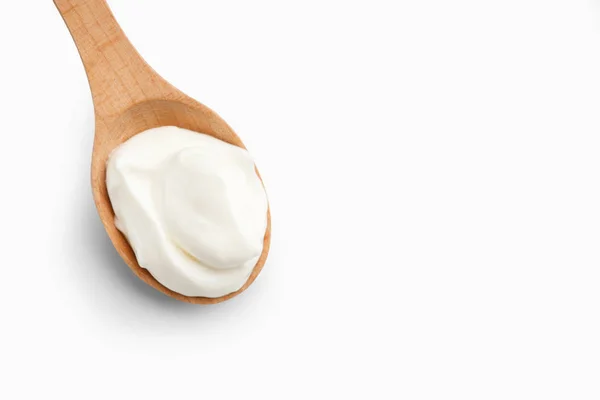 Greek yogurt in wooden spoon, copy space — Stock Photo, Image