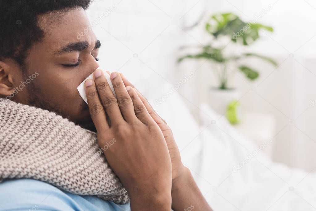 African-american man man has runny nose at home