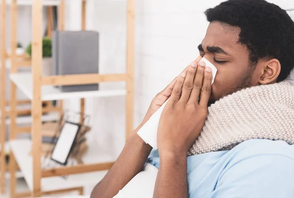 African-american man man has runny nose at home — Stock Photo, Image