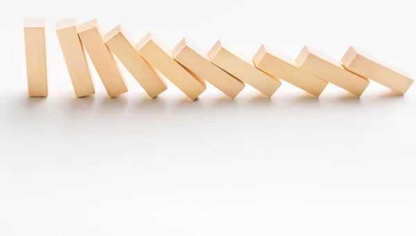 One yellow wooden block stop other ones falling like dominoes — Stock Photo, Image