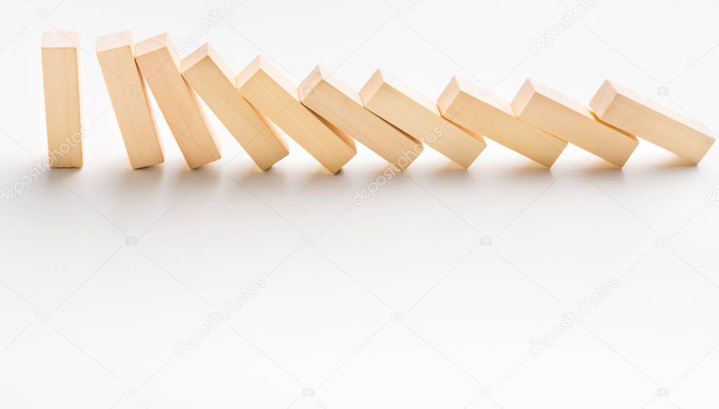 One yellow wooden block stop other ones falling like dominoes